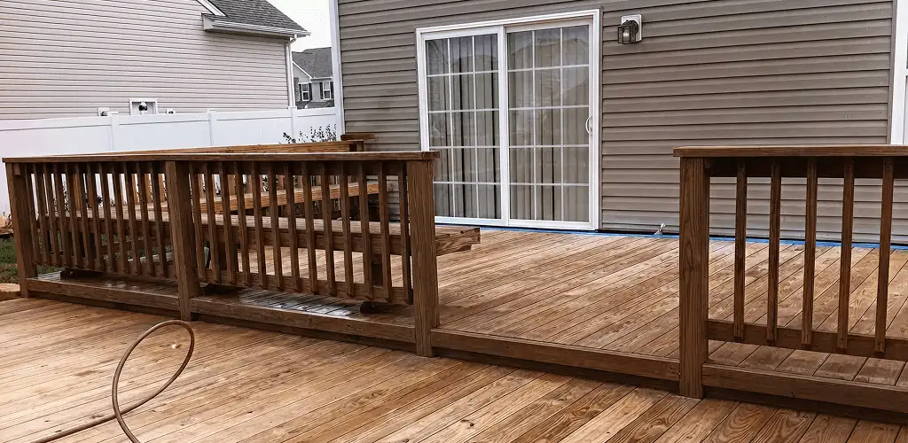 Deck sealing service protecting a backyard wood deck and railings in Cleveland, OH