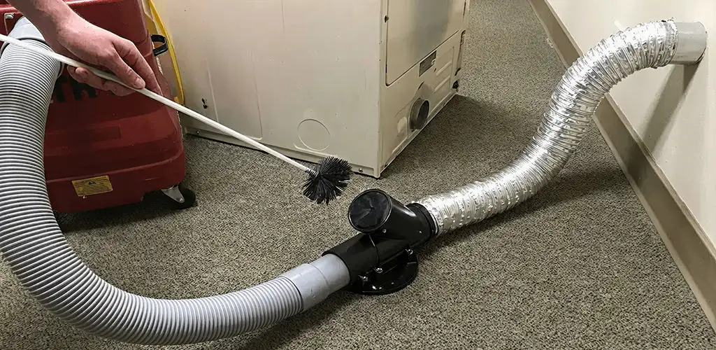 Dryer vent cleaning service removing lint from a dryer duct connection in Cleveland, OH