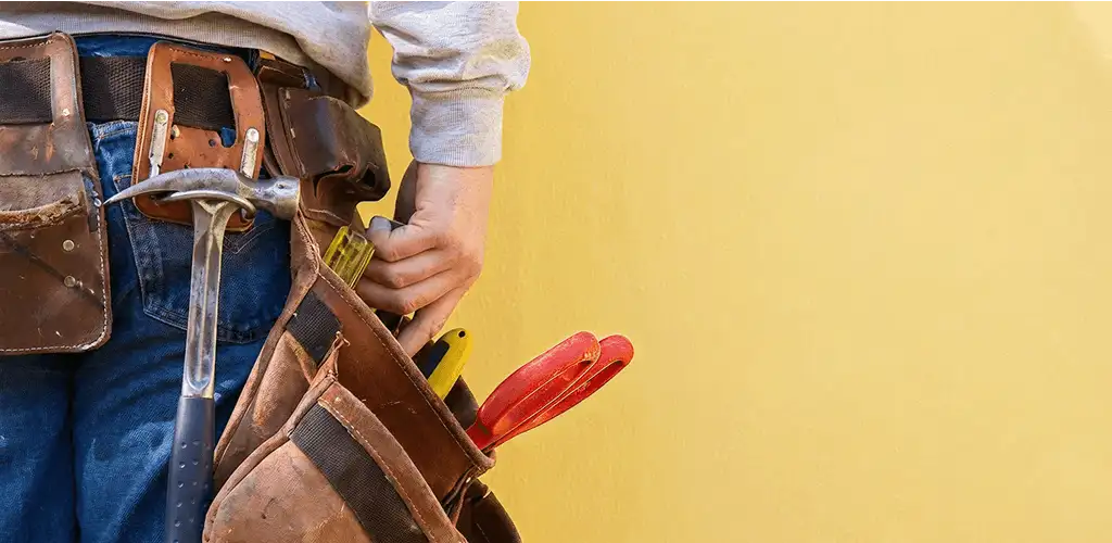 Handyman with tool belt ready for home repairs and maintenance in Cleveland, OH