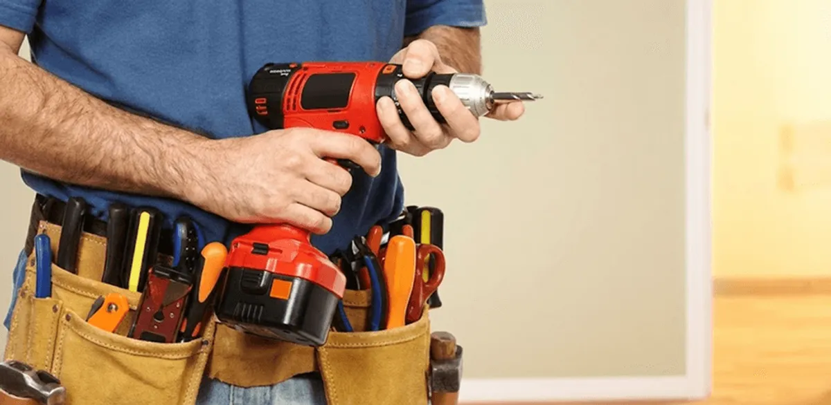 Handyman holding a power drill for home repairs and installations in Cleveland, OH