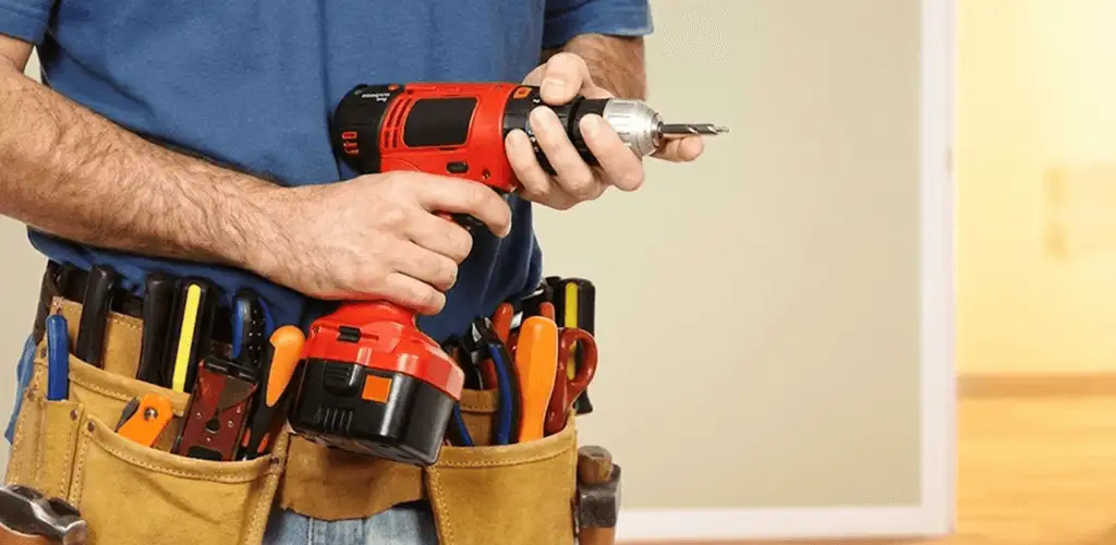 Handyman holding a power drill for home repairs and installations in Cleveland, OH